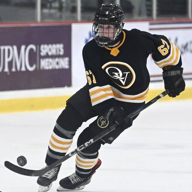 Quaker Valleys Charlie Pyle carries the puck up-ice against Moon on Monday, Nov. 24, 2025, at RMU Island Sports Center. (Christopher Horner | TribLive)