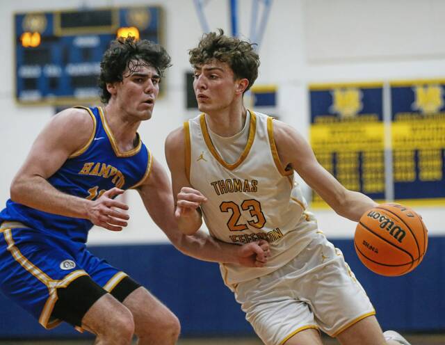 Thomas Jeffersons Nick Trkja drives against Hamptons Zack Danner during their WPIAL semifinal Feb. 24 at Mt. Lebanon. (Mike Darnay | Mon Valley Independent)