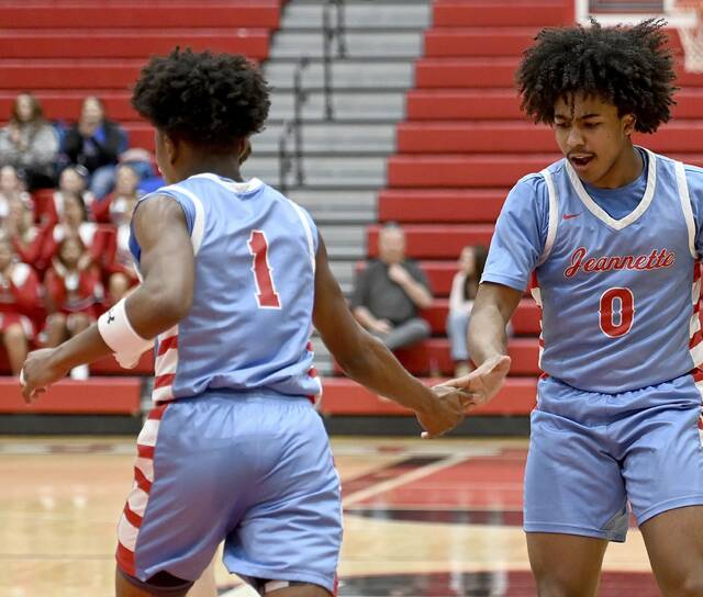 Jeannette’s Kymon’e Brown (1) celebrates with Xavier Odorisio-Farrow after dunking against Jefferson Morgan during their PIAA Class 2A state playoff game on Wednesday, Mar. 11, 2026, at Peters. (Christopher Horner | TribLive)