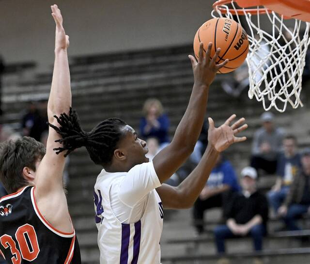 Obama Academys Eric James scores past Cathedral Preps Michael Thompson during their PIAA Class 4A playoff game on Tuesday, March 10, 2026, at Sharon High School. (Christopher Horner | TribLive)