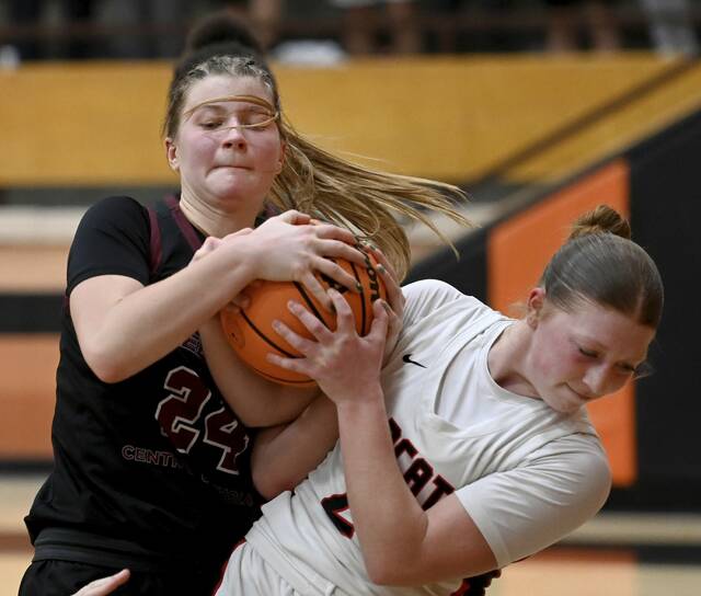 Greensburg Central Catholics Abigail Dlugos battles Northwesterns Courtney Eddy for a loose ball during their PIAA Class 3A playoff game on Tuesday, March 10, 2026, at Sharon High School. (Christopher Horner | TribLive)
