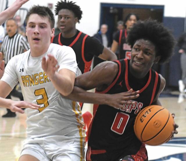 Aliquippas Anthony Ingram drives to the hoop against Forest Hills Koy McGough during a PIAA Class 3A playof game Wednesday. (Paul Schofield | TribLive)