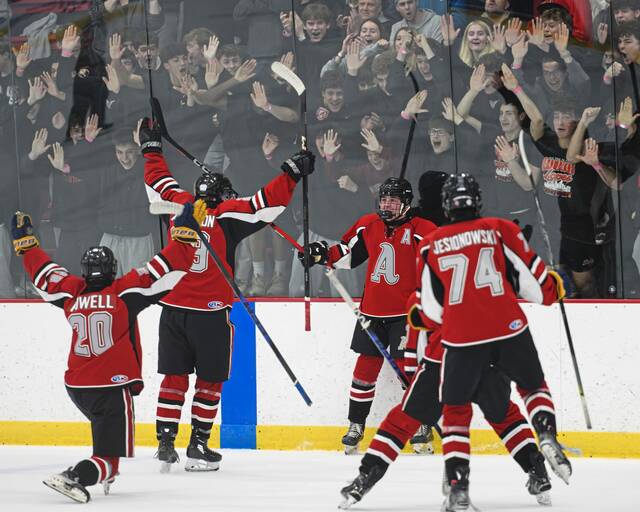 Avonworth's Jack Dolan (center) celebrates with his team after a goal against Canon-McMillan in the PIHL Class A semifinals Wednesday, March 11, 2026, at the RMU Island Sports Center. (Andrew Palla | For TribLive)