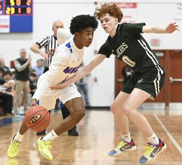 Jeannettes Kymone Brown is fouled by Mercyhursts Ashton Wilbur during a first-round PIAA game last year. (Chaz Palla | TribLive)