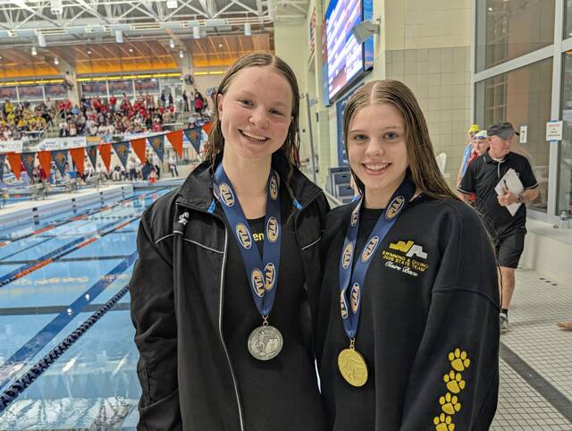 Fox Chapels Ellie Lange (left) took second, and North Alleghenys Claire Bacu (right) took first in the 500 free at the PIAA Class 3A swimming championships Thursday. (Michael Love | TribLive)