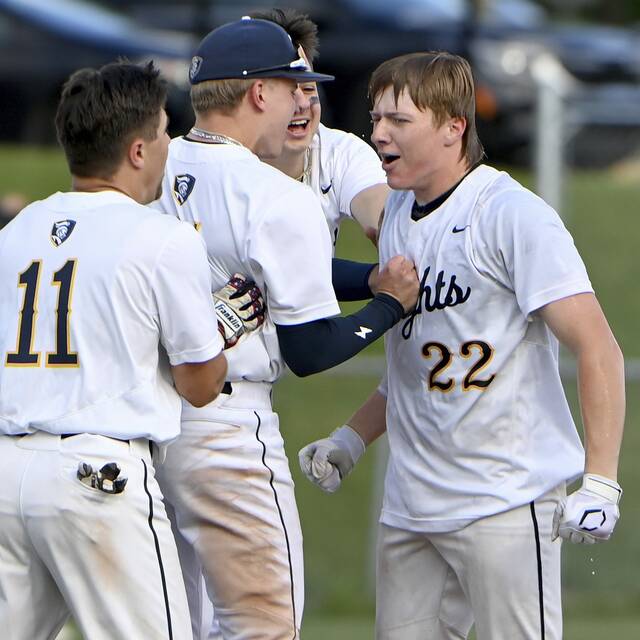Norwins Trevor Vitsas (22) is mobbed by teammates after the Knights defeated Butler in nine innings in a WPIAL Class 6A quarterfinal May 19, 2025, at North Allegheny. (Christopher Horner | TribLive)