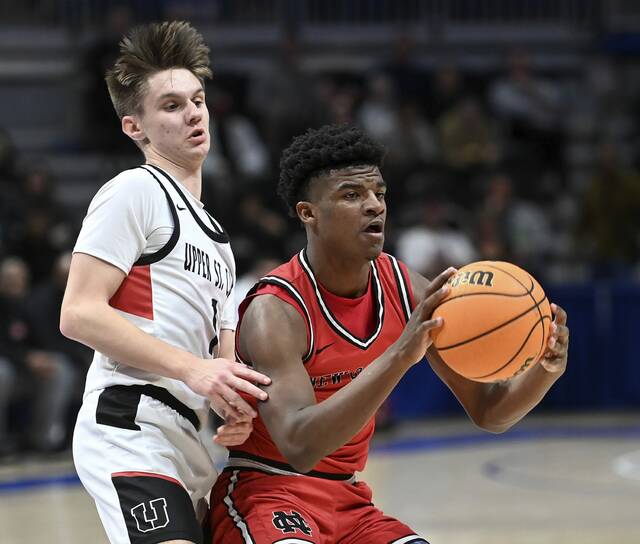 New Castles Damian Harrison works against Upper St. Clairs Luke Marchinsky during the WPIAL Class 6A championship game Feb. 27. (Christopher Horner | TribLive)