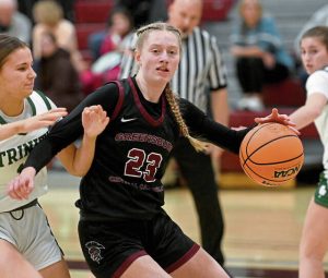 Greensburg Centrals Erica Gribble drives to the basket past Trinitys Kendall Ferraro during their PIAA Class 3A quarterfinal Friday at Altoona. (Christopher Horner | TribLive)