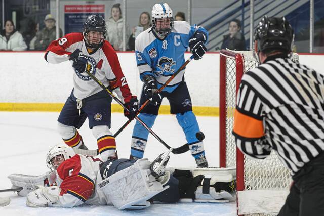 Morgantown goaltender Ryan Lowe (bottom) allows the winning goal by Burrell in overtime of the PIHL Penguins Cup D2 senifinals Thursday. (Andrew Palla | TribLive)