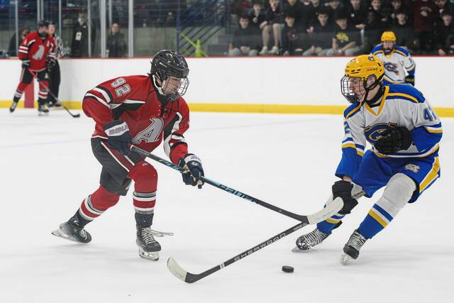 Avonworth's Jack Sutch (92) lugs the puck into the offensive zone amidst pressure from Canon-McMillan's Connor Stokes (42) in the PIHL Class A semifinals Wednesday, March 11, 2026, at the RMU Island Sports Center. (Andrew Palla | For TribLive)