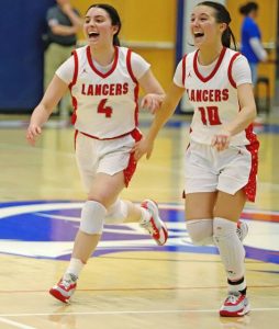 Lily Rowe, left, and Nina Medure, right, run toward the student section to celebrate following the PIAA Class 2A semifinal Monday, March 16, 2026 at Armstrong High School. (Josh Rizzo | For TribLive)