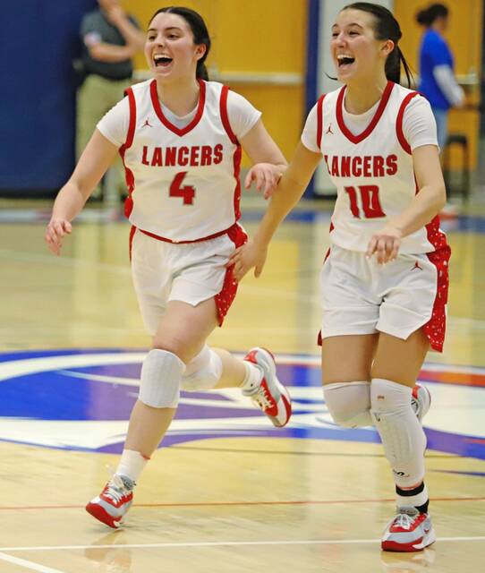Lily Rowe, left, and Nina Medure, right, run toward the student section to celebrate following the PIAA Class 2A semifinal Monday, March 16, 2026 at Armstrong High School. (Josh Rizzo | For TribLive)