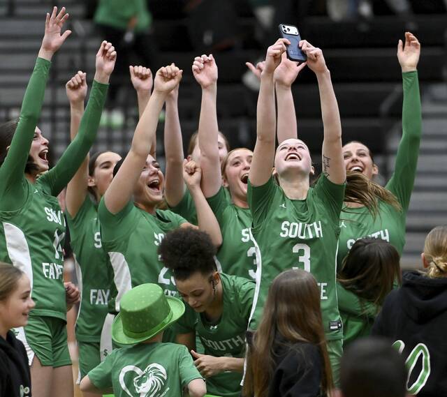 The South Fayette girls basketball team celebrates with fans after defeating Peters Township in their PIAA Class 5A semifinal Tuesday. (Christopher Horner | TribLive)