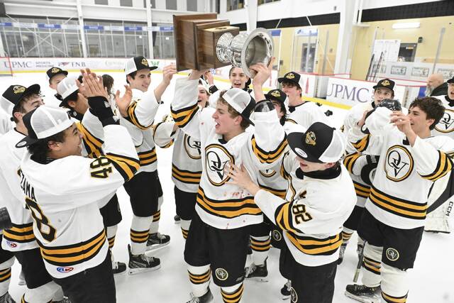 Quaker Valley celebrates with the Penguins Cup after beating Avonworth in the PIHL Class A championship game Tuesday at UPMC Lemieux Sports Complex. (Chaz Palla | TribLive)
