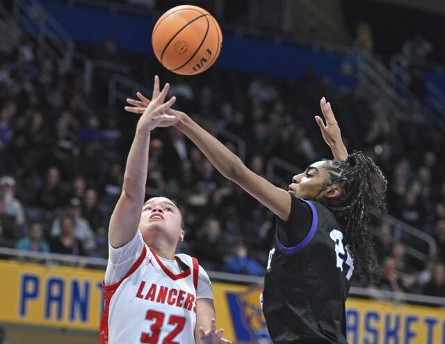 Neshannocks Payton Newman scores past Winchester Thurstons DaShae Cochran during the WPIAL Class 2A girls basketball championship game Feb. 28 at Petersen Events Center. (Chaz Palla | TribLive)