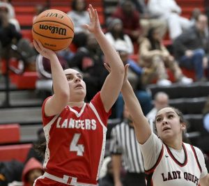 Neshannocks Lily Rowe scores past Aliquippas Jayona Patrick on Feb. 4 at Aliquippa. (Christopher Horner | TribLive)