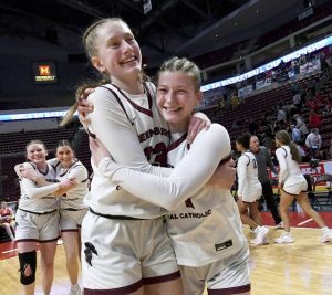Greensburg Central’s Erica Gribble hugs Abigail Dlugos after defeating Holy Redeemer in the PIAA Class 3A state championship game on Thursday, Mar. 19, 2026, at Giant Center in Hershey. (Christopher Horner | TribLive)