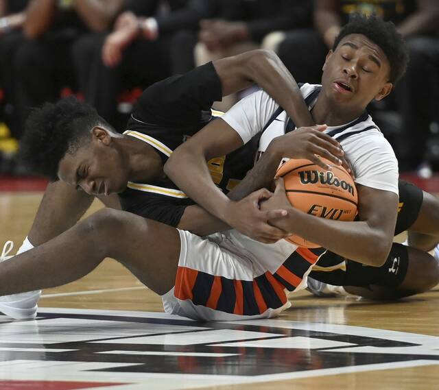 The Neighborhood Academys Dante Wright battles Sankofa Freedom Academys Nasir Brown for a loose ball during the PIAA Class A championship game on Thursday, March 19, 2026, at Giant Center in Hershey. (Christopher Horner | TribLive)