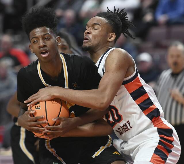 The Neighborhood Academy’s Trey McMurray battles Sankofa Freedom Academy’s Nasir Brown for a loose ball during the PIAA Class A state championship game on Thursday, Mar. 19, 2026, at Giant Center in Hershey. (Christopher Horner | TribLive)