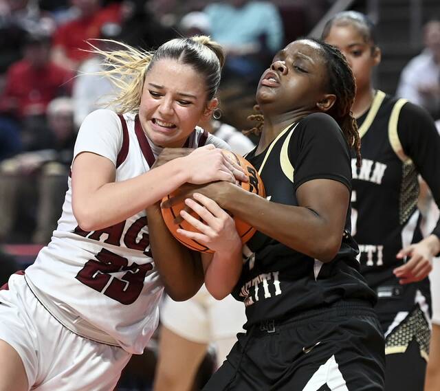Oakland Catholics Luci LaMendola battles Neumann-Gorettis Zion Coston for the ball during the PIAA Class 4A championship game Saturday at Giant Center in Hershey. (Christopher Horner | TribLive)