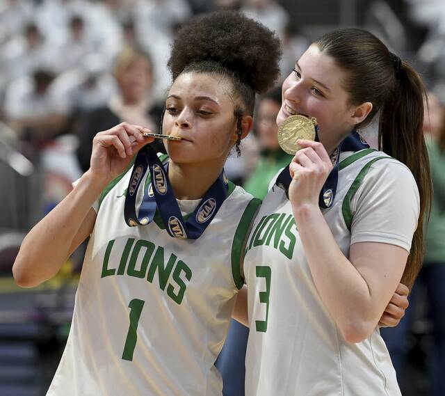 South Fayettes Lailah Wright hugs Haylie Lamonde after receiving their gold medals following the PIAA Class 5A championship game against Archbishop Wood on Saturday, March 21, 2026, at Giant Center in Hershey. (Christopher Horner | TribLive)