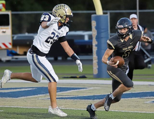 Franklin Regionals Tommy Verruggio attempts to track down Kiski Area quarterback Aven Shirley during a game last season. (Josh Rizzo | For TribLive)
