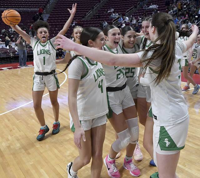 The South Fayette girls basketball team celebrates after defeating Archbishop Wood in the PIAA Class 5A championship game Saturday at Giant Center in Hershey. (Christopher Horner | TribLive)