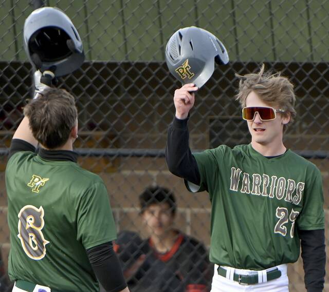 Penn-Traffords Jordan White greets Aiden Drotos at home plate after Drotos hit a two-run homer against Latrobe on Tuesday in Harrison City. (Christopher Horner | TribLive)
