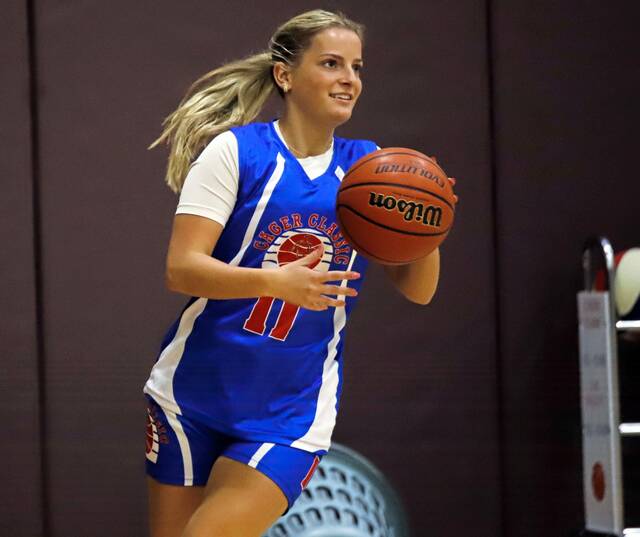Knoch senior Neah Ewing checks the clock during the individual hotshot competition Friday at the 29th annual Cager Classic Skills competition. Ewing beat Kiskis Alison Pencak in the finals. (Josh Rizzo | For TribLive)