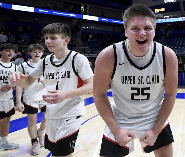 Upper St. Clair’s Ryan Robbins celebrates next to Luke Marchinsky after defeating New Castle, 52-51, in the WPIAL Class 6A championship game on Friday, Feb. 27, 2026, at Petersen Events Center. (Christopher Horner | TribLive)