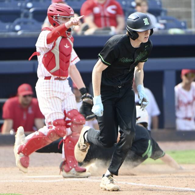 Riversides Logan Young drives in a run with a squeeze bunt during the sixth inning against Mount Carmel in the 2025 PIAA Class 3A championship game. (Christopher Horner | TribLive)