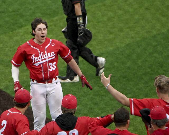 Indianas Charlie Manzi isgreeted at home plate by teammates after hitting a walk-off two-run homer in the bottom of the 10th inning of the 2025 WPIAL Class 4A championship game against Elizabeth Forward. (Christopher Horner | TribLive)