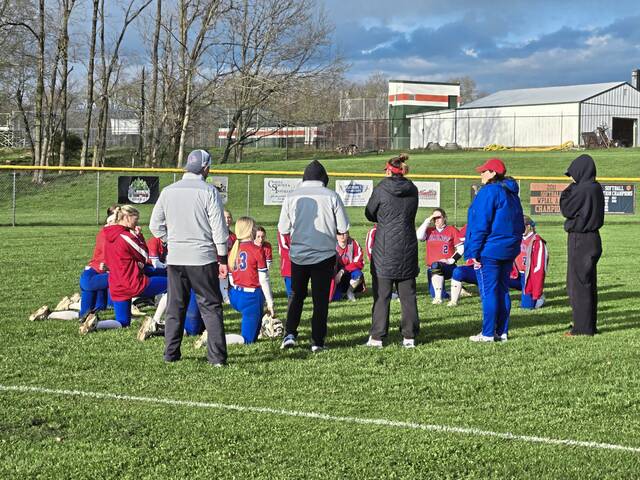 Mt. Pleasant players and coaches huddle after Monday's 12-6 victory at Yough. (Bill Beckner Jr. | TribLive)