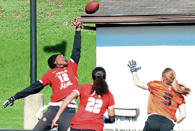 Penn Hills Aniyah Hickman tips a ball during a flag football game last season at Woodland Hills. (Josh Rizzo | For TribLive)