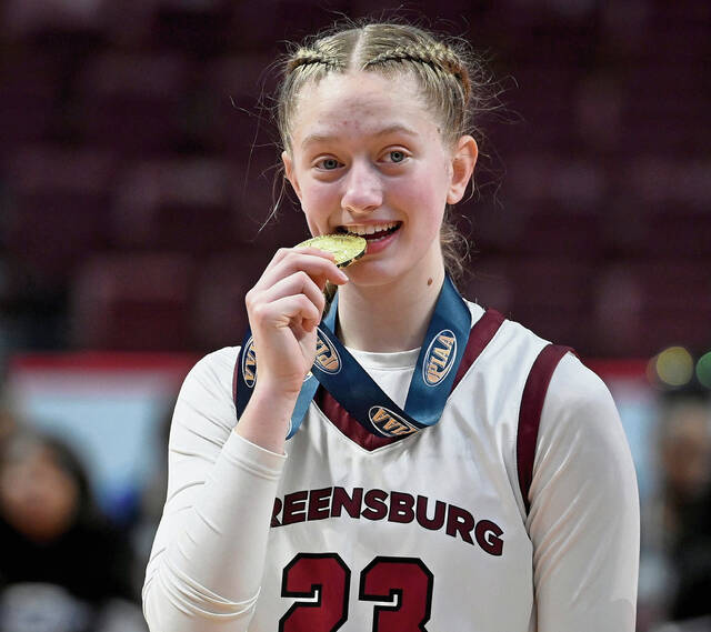 Greensburg Central’s Erica Gribble celebrates with her gold medal after defeating Holy Redeemer in the PIAA Class 3A state championship game on Thursday, Mar. 19, 2026, at Giant Center in Hershey. (Christopher Horner | TribLive)