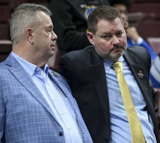 WPIAL executive director Vince Sortino talks with PIAA executive director Mark Byers during the PIAA Class 4A championship game on Saturday, March 21, 2026, at Giant Center in Hershey. (Christopher Horner | TribLive)