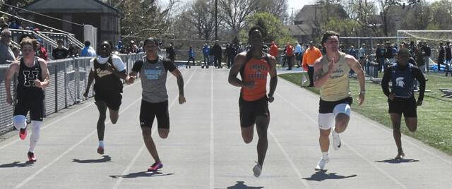 Latrobe junior Preston Miller wins the 100-meter dash at the Lady Spartan/Wildcat Invitational on April 11. (Paul Schofield | TribLive)