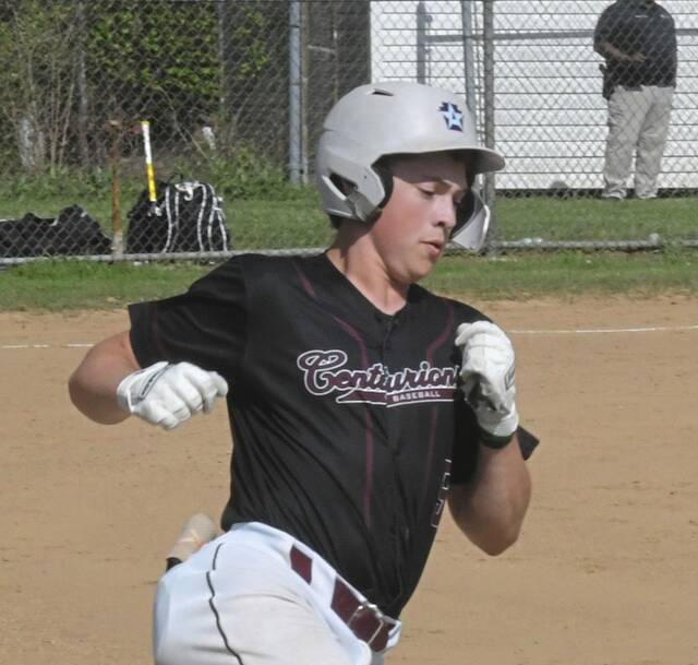 Greensburg Central Catholic shortstop Stephen Kochis runs to second base after hitting an RBI double against Carmichaels on Wednesday. (Paul Schofield | TribLive)