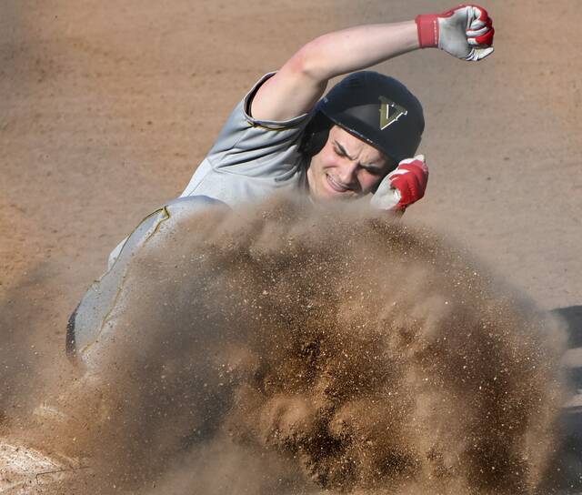 Valleys Nikolas Heakins slides into third base against Greensburg Salem on April 9. (Christopher Horner | TribLive)