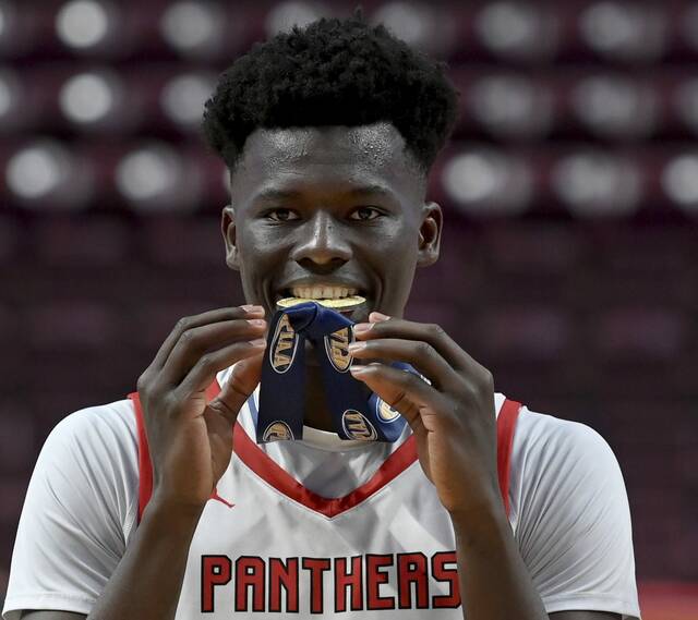 Sewickley Academys Mamadou Kane celebrates with his gold medal after defeating Old Forge in the PIAA Class 2A championship game on Friday, March 20, 2026, at Giant Center in Hershey. (Christopher Horner | TribLive)