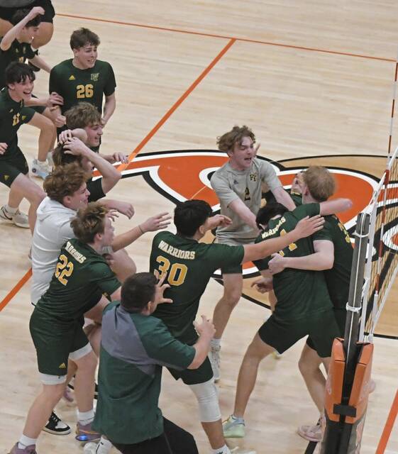 Members of the Penn-Trafford boys volleyball team celebrate win against No. 3 Latrobe on May 15, 2025. (Paul Schofield | TribLive)