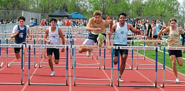 Franklin Regional junior Sean Cartwright clears the final hurdle in the 110-meter hurdles at the Westmoreland County Coaches Association meet on April 23. (Paul Schofield | TribLive)