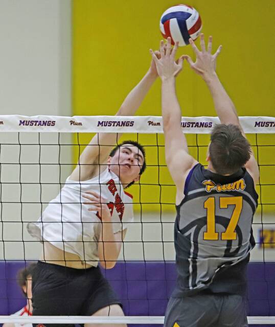 Fox Chapels Leonidas Vandapel attempts to pick up a kill by hitting over the block of Plums Joseph Bonazza on Tuesday, April 28, 2026 at Plum High School. (Josh Rizzo | For TribLive)