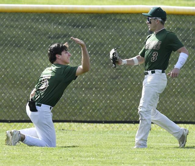 Penn-Trafford outfielders Logan Matrisch (left) and Nico Casciato celebrate after making back-to-back diving catches against Franklin Regional on Monday. (Christopher Horner | TribLive)