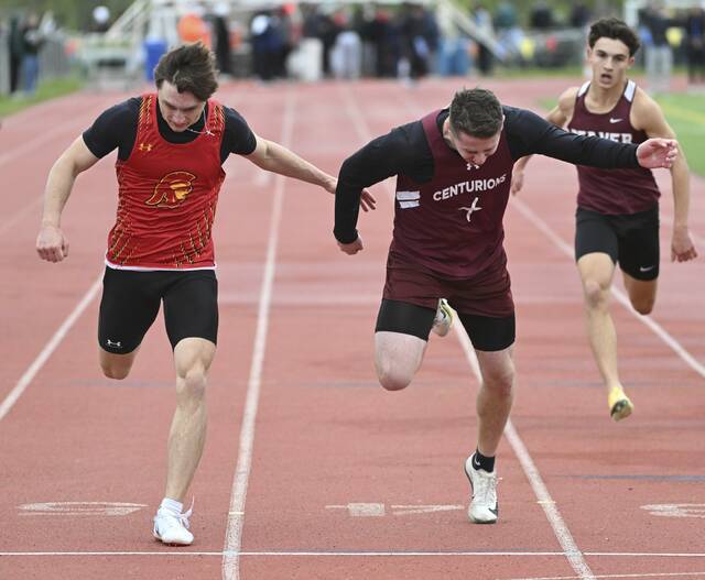 Greensburg Central Catholics Jerry Davis edges North Catholics Logan Schade in the 400-meter run during the WPIAL Class 2A Track and Field Championships on Thursday at Slippery Rock University. (Chaz Palla | TribLive)