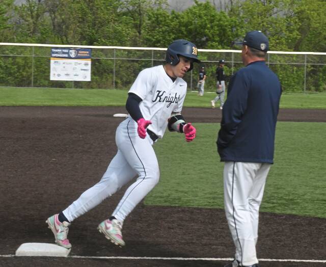 Norwin senior second baseman Tristyn Tavares is congratulated by coach Craig Spisak after hitting a home run in the fourth inning on April 30. (Paul Schofield | TribLive)
