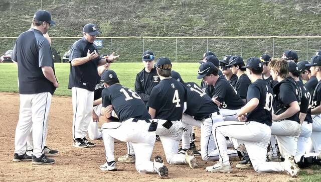 Norwin baseball coach Craig Spisak (second from left) talks to his team after a victory at Hempfield. (Bill Beckner Jr. | TribLive)