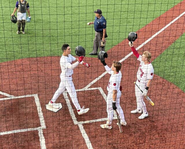 Teammates congratulate Moons Andrew Cross after he hit his second home run of the game in a WPIAL Class 5A first-round playoff game against Baldwin on May 12. (Don Rebel | TribLive)