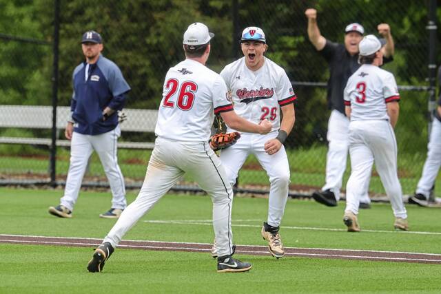 Elizabeth Forward’s Joseph Crovak (29) and Jacob Peterson (26) celebrate after recording the final out to defeat Hopewell, 4-3, in a WPIAL Class 4A semifinal Wednesday, May 20, 2026, at Washington & Jefferson College in Washington. (Jeff Helsel | Mon Valley Independent)