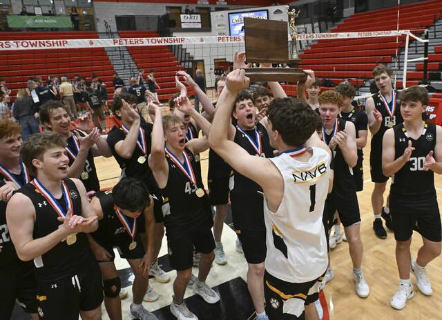 North Allegheny celebrates with the trophy after beating Butler in the WPIAL Class 3A Volleyball Championship on Wednesday at Peters Township. (Chaz Palla | TribLive)